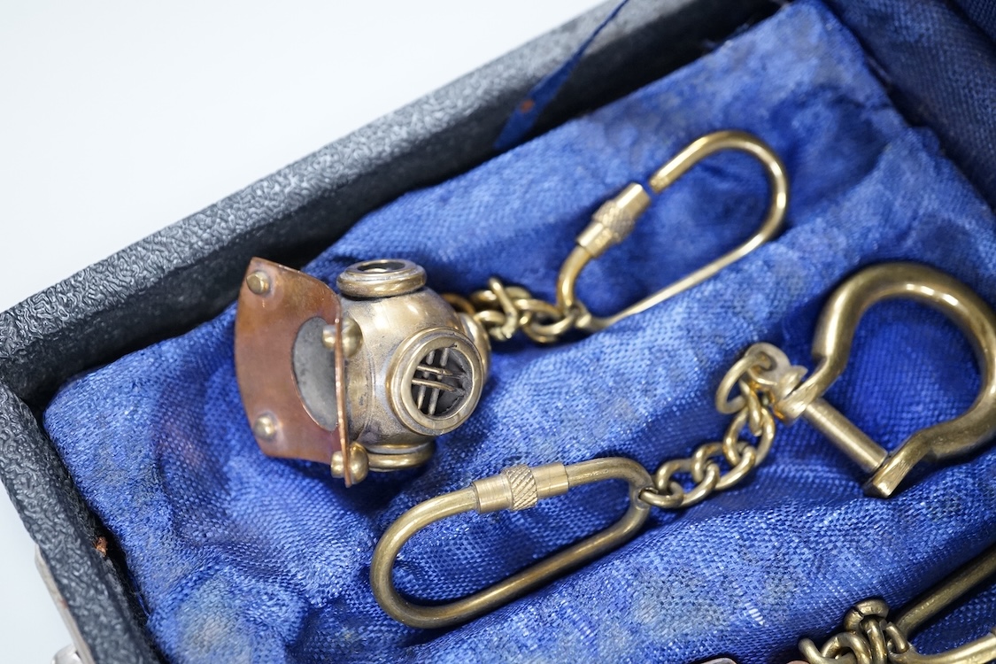 A cased set of enamelled naval buttons and similar keyrings